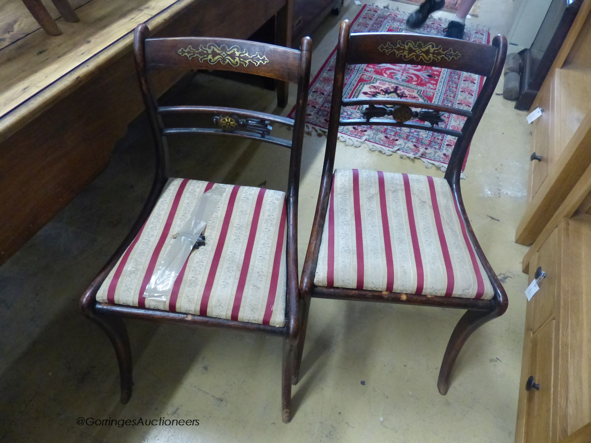 A set of five Regency brass inlaid simulated rosewood cane seated dining chairs